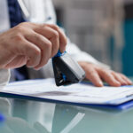 doctor holding medical stamp to put on prescription paper doctor holding medical stamp to put on prescription paper